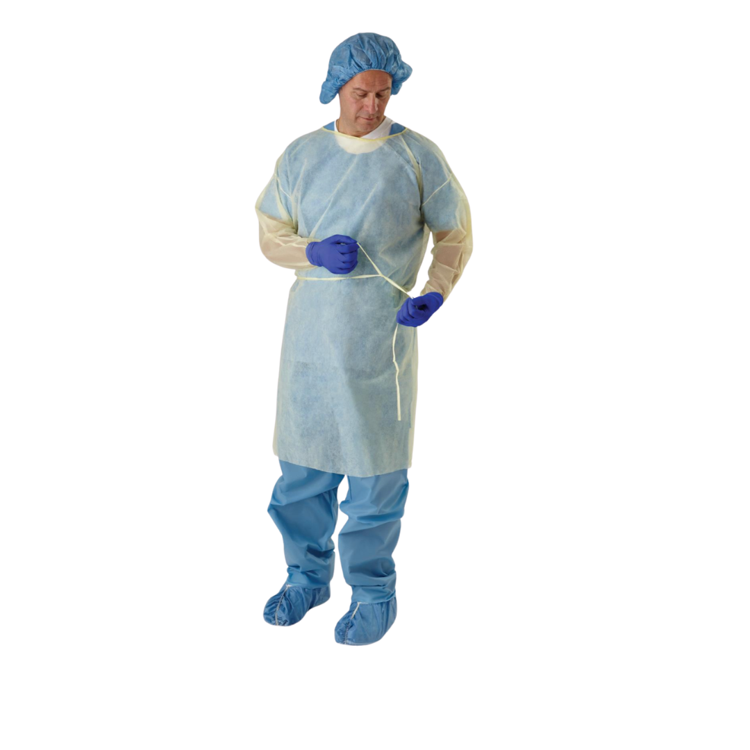 Wearing blue scrubs, gloves, shoe covers, a hair cover, and a Medline Disposable Full Back Spunbond Cover Gown, a person ties the gown’s waist strap while standing against a white background.